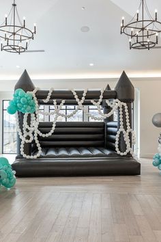 an inflatable castle with balloons and streamers on the floor is ready to be set up for a party