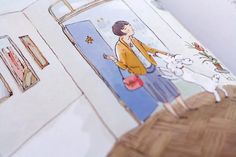 an open children's book with illustrations of a woman and her dog in the doorway