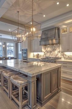 a large kitchen with marble counter tops and an island in front of the stove top