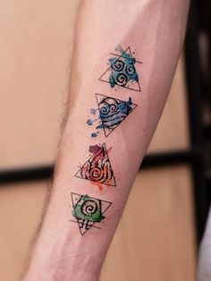 a person with a tattoo on their arm has four different designs on it's arm