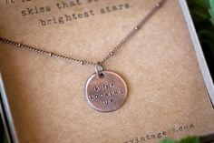 "\"It is often in the darkest skies that we see the brightest stars.\" This distressed, 3/4\" wide solid copper pendant is hand-stamped with the phrase, \"KEEP LOOKING UP\" and hung on an antique copper satellite chain. Your necklace will arrive ready-to-gift in a natural kraft jewelry box (as shown in the images) with a cotton twine bow tied around it. [ABOUT HANDSTAMPING] Please keep in mind that each letter is individually stamped by hand. The metal tools I use are not aligned and pressed by Everyday Inspirational Hand Stamped Necklaces, Copper Stamped Necklace Perfect For Gifts, Adjustable Hand Stamped Meaningful Necklace, Inspirational Hand Stamped Everyday Necklace, Copper Stamped Necklace For Gift, Inspirational Stamped Necklace As Gift, Hand Stamped Keepsake Pendant Jewelry, Twine Bow, Keep Looking Up