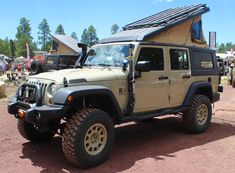 a jeep with a tent on the roof