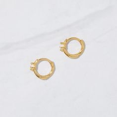 Super cute opal huggie earrings! They snug the ear just right! Made of 925 Sterling Silver We use a THICK, DURABLE plating of 14K Gold, Rose Gold or Rhodium - for a piece that will last you years to come! Lab created opals - we use highest grade for an authentic look! Nickel-free & Hypoallergenic Dimensions: Inner Diameter: 7.8mm Outer Diameter: 10.3mm Thickness: 1.8mm Gold Minimalist Huggie Earrings In Sterling Silver, Gold Sterling Silver Minimalist Huggie Earrings, Gold Minimalist Sterling Silver Huggie Earrings, Gold Plated Minimalist Round Cartilage Earrings, Minimalist Gold-plated Huggie Earrings, Minimalist Gold Plated Huggie Earrings, Minimalist Gold-plated Cartilage Earrings, Trendy Yellow Gold Cartilage Earrings As Gift, Tiny Gold Minimalist Huggie Earrings