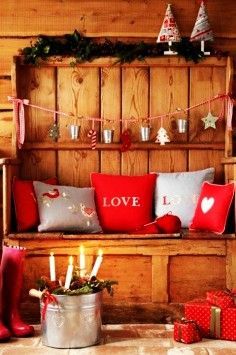 a bench with christmas decorations and candles on it