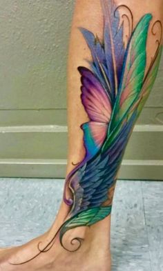 a woman's foot with a colorful tattoo on it