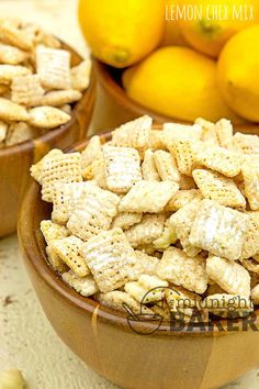 two bowls filled with lemon chex mix next to some lemons and oranges