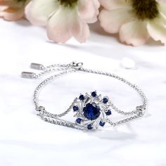 Exquisite and stunning, this bracelet will capture your heart at first sight. Inspired from ballerina's dancing dress, it presents an elegant silhouette that will remain endlessly enchanting. Glistening double halo surrounds the blue center stone to create a sparkling and luxurious look. The bolo bracelet is easy to adjust to fit every lady's wrist. Add this masterpiece to your jewelry box and you won't be disappointed.Carat Weight: 3.6 ctStone Size: 8 mmStone Type: Jeulia® StoneNumber of Stones Bolo Bracelet, Blue Sapphire Diamond, Bracelet Online, Flower Bracelet, Bracelet Sizes, Quality Jewelry, Sterling Silver Bracelets, Blue Sapphire, Round Cut