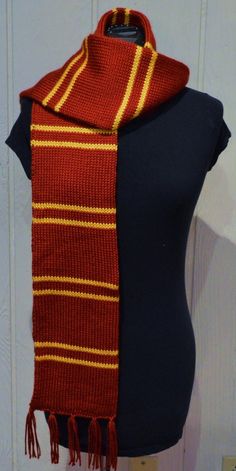 a red and yellow striped scarf on a mannequin