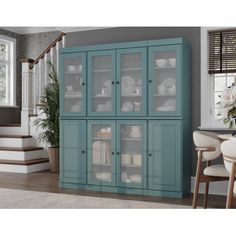 a blue china cabinet with glass doors next to stairs