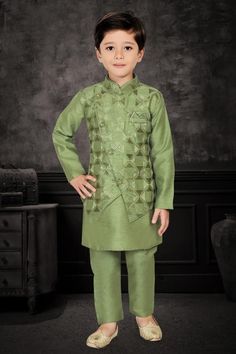 Enhance your little one's appearance on special occasions with this exquisite three-piece kurta pyjama set. The cotton kurta, adorned in a mehendi green hue, features plain patterns that add an elegant touch. The matching overcoat, embellished with scattered embroidered checks, imparts a festive aura. The asymmetrical overcoat, featuring a front button closure, complements the ensemble, while the matching bottoms complete the look with finesse.  Note: Colors may slightly vary due to photographic Green Bandhgala With Zari Work For Eid, Festive Green Sherwani With Straight Kurta, Designer Green Sherwani For Diwali, Green Designer Sherwani For Diwali, Green Sherwani For Diwali, Green Straight Kurta Sherwani For Festivals, Green Bandhgala With Traditional Drape For Eid, Bollywood Style Green Bandhgala For Eid, Green Traditional Bandhgala For Eid