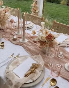 the table is set with plates, silverware and napkins for an elegant dinner