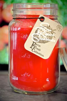 a jar filled with red liquid sitting on top of a table