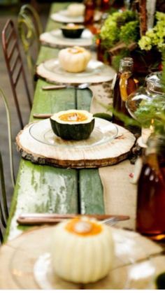 a long table with plates and bowls on it