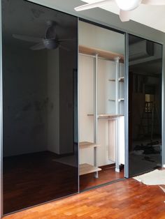 an empty room with sliding glass doors and hard wood flooring