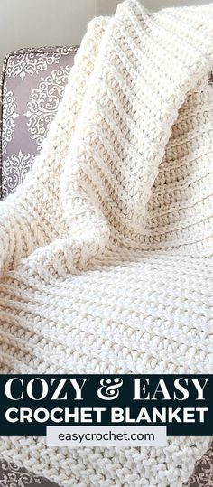 a white crocheted blanket sitting on top of a couch with the text cozy & easy crochet blanket