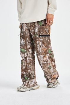 The Withered Leaves Crinkled Camo Cargo Pants are an outdoor leisure garment, featuring a camouflage pattern composed of tree branches and leaves. Dominated by brown and green tones, these pants are ideally suited for outdoor activities and casual wear. Fashion-forward and highly functional, they are perfect for individuals who enjoy outdoor adventures and appreciate natural scenery. The pants are designed with zippered pockets on the front, offering secure and convenient storage for personal it Recycled Outfits, Camo Cargo Pants, Brown And Green, Outdoor Leisure, Natural Scenery, Green Tones, Outdoor Adventures, Tree Branches, Male Model