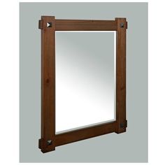 a wooden frame mirror hanging on the wall with an arrow shaped handle around it's edge