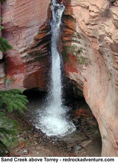 there is a small waterfall coming out of the rocks