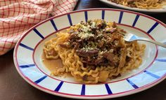 two plates of pasta with meat and parmesan cheese