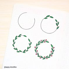 a notebook with two wreaths drawn on it