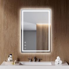 a bathroom sink with a lighted mirror above it