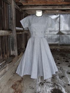 "This is a vintage black and white cotton blend full skirt dress from the 1950's. It features short kimono sleeves, a fitted midriff with 2 rows of loops, and a full circle skirt. The skirt is completely lined in black buckram to keep it's shape. This dress opens down the back with a well working metal zipper. There is a little discoloration at the underarms, but I have not had this dress cleaned. The label is from \"Coplin's\", which was a very nice women's shop in Milwaukee. Comes from a smoke Fitted Cotton Vintage Dress, Tea Length, Vintage Cotton Fit And Flare Dress, Fitted Cotton Vintage Tea-length Dress, Fitted Tea-length Vintage Cotton Dress, 1950s Short Sleeve Cotton Dress, 1950s Style Short Sleeve Cotton Dress, 1950s Style Short Sleeve Cotton Vintage Dress, 1950s Style Cotton Dresses With Short Sleeves, Vintage Short Sleeve Dresses With Fitted Waist