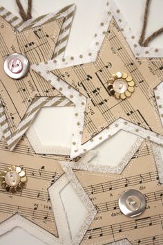 an ornament made out of sheet music with buttons and string attached to it