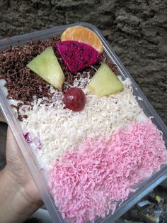 a plastic container filled with rice and fruit