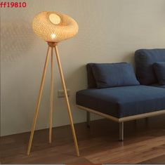 a floor lamp next to a blue couch