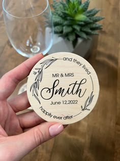 a person holding up a wooden coaster that says mr and mrs smith