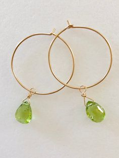 "Lovely apple green genuine peridot pear drops wire wrapped on delicate 1\" 14k gold hoops. Petite faceted peridot briolettes are 7 x 10mm and hang from handmade 1\" 14k gold fill wire hoops. Total drop length is 1 3/4\". Also available in Sterling silver. A lovely sparkly August birthday gift!" Teardrop Peridot Jewelry For Anniversary, Green Peridot Wire Wrapped Jewelry, Teardrop Peridot Jewelry For May Birthstone, Teardrop Peridot Birthstone Jewelry, Green Briolette Jewelry With Ear Wire, Green Briolette Wire Wrapped Jewelry, Yellow Gold Peridot Teardrop Jewelry, August Birthday, Aquamarine Earrings