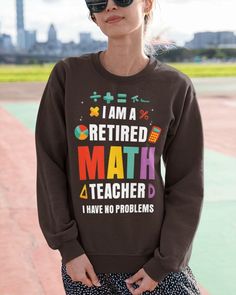 a woman wearing a red sweatshirt with the words i am a retired math teacher and i have no problems