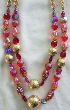 "Vintage Beaded Choker / Necklace: Two-Strand Pink & Red Glass with Gold Metal Accent Beads Unusual 1950s-1960s Pretty 50s-60s necklace, with gorgeous pink and red glass beads of various shapes and types with different sizes of round gold metal beads and chunky gold chain. Hook clasp; unmarked. This necklace is truly gorgeous--the beads sparkle and shimmer. 17\" long / 20.5\" long with extender...this is a choker." Vintage Red Jewelry For Holidays, Red Vintage Jewelry For Holidays, Red Vintage Holiday Jewelry, Vintage Colorful Beaded Necklaces For Festive Occasions, Retro Red Necklace For Party, Vintage Red Necklace For Celebration, Red Vintage Necklace For Celebration, Vintage Polished Beads For Festive Occasions, Festive Vintage Beaded Necklaces With Polished Beads