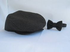 Page boy hat, bow tie and suspenders set. Classic wedding photo hat. Perfect one year old birthday photo prop or ring bearer hat set. More than just a prop, this cap may become the hat your toddler wears every where. All caps are handmade and each hat is custom created to the size you need. You may choose the flat cap, suspenders and bow tie set or any combination of the three pieces. You may purchase the only one of the items if you wish. You may purchase any combination of the three items in t