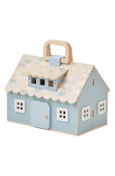 a wooden toy house with a blue roof