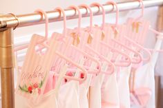 there are many pink bags hanging on the rack