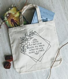 a tote bag sitting on top of a table next to some books and other items