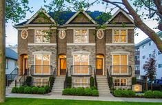 a two story brick house with many windows and balconies on the second floor