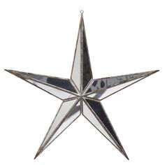 a metal star ornament hanging on a white wall with a black and silver background