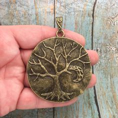 You will receive 3 - Bronze Tree Pendant in a Disk by TIJC! These charms are a quality Pewter for all your jewelry and crafting projects! - (3) Bronze Tree Charm - 84x64x11mm ( 25.4mm = 1 inch ) - Quality Pewter - Item # SP1467B Use to Make Tree of Life Necklace Tree of Life Jewelry Tree of Life Pendant All Items will come as shown in a poly bag! Etched Jewelry, Tree Charms, Diy Jewelry To Sell, Necklace Tree, Tree Of Life Jewelry, Gold Cross Pendant, Tree Of Life Necklace, Clay Jewelry Diy, Tree Necklace