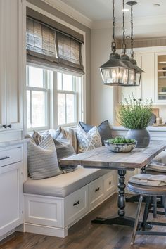 a kitchen with a table, stools and bench in the middle of the room