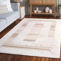 a living room with a white rug on the floor