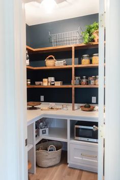 an open pantry with shelves and baskets