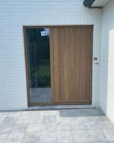 a white brick building with a wooden door