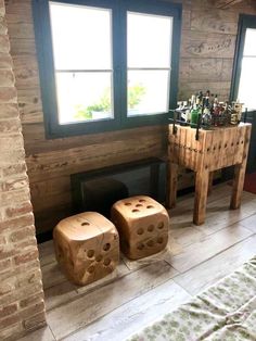 two wooden dice stools sitting in front of a fireplace