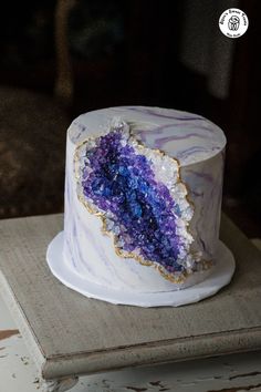 a white cake with purple and blue frosting