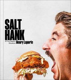 a man eating a large sandwich with his mouth open