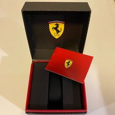 a ferrari watch in a red box on a white table