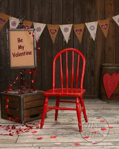 a red chair sitting in front of a wooden box with a sign that says be my valentine