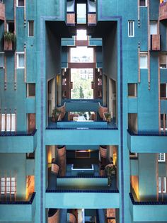 an apartment building with multiple balconies and blue walls